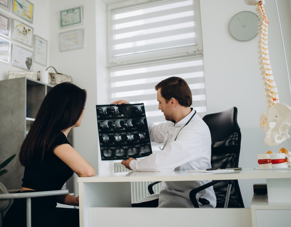 Female patient examining spine at physiotherapist at vertebrology center