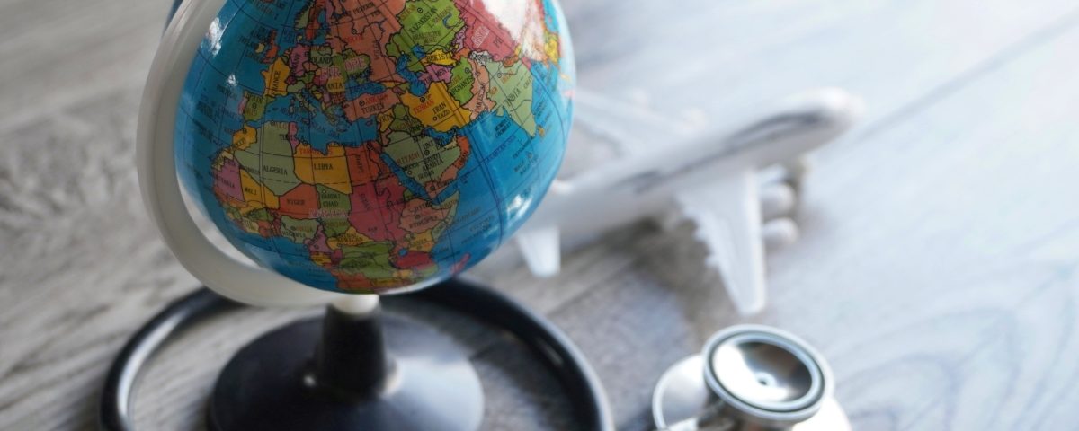 Selective focus image of globe, toy plane and stethoscope.