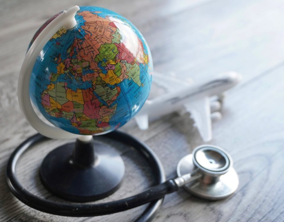 Selective focus image of globe, toy plane and stethoscope.