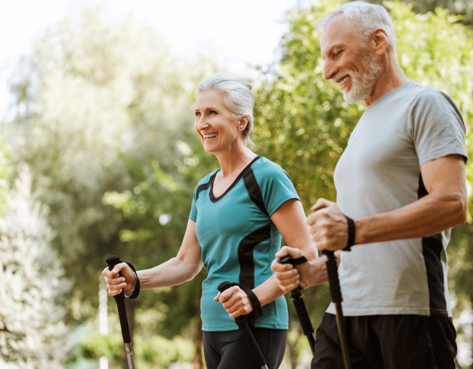 Senior couple engaging in nordic walking for fitness and well-being