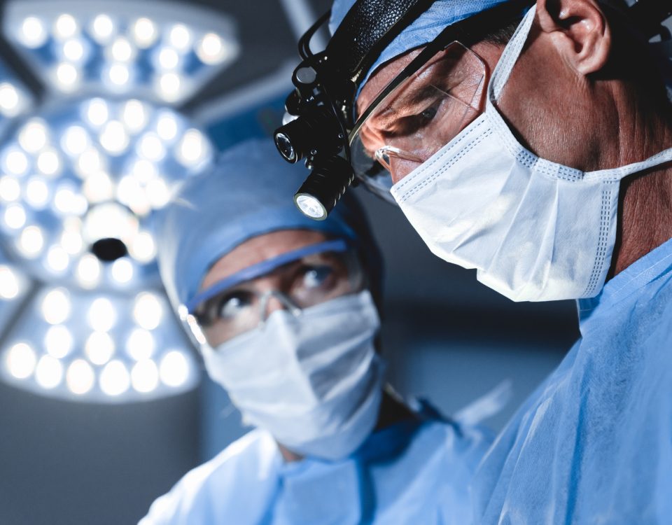 Surgeons working in operating room in modern hospital