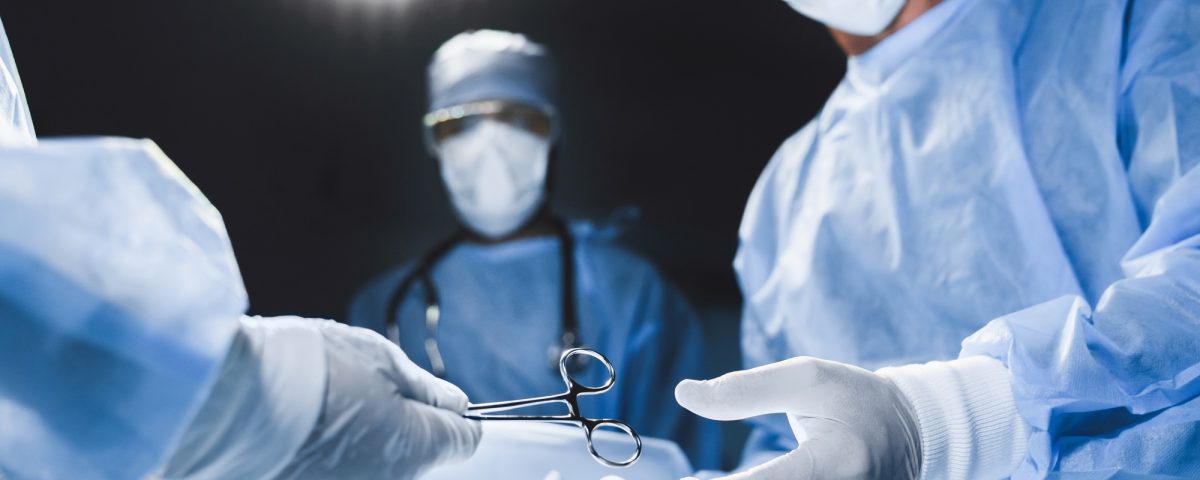 Close up of surgery team operating in moern hospital.