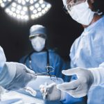 Close up of surgery team operating in moern hospital.