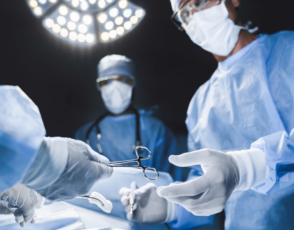 Close up of surgery team operating in moern hospital.