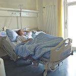 photo of woman lying in hospital bed