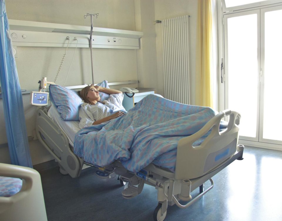 photo of woman lying in hospital bed